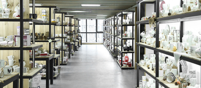 Wholesale ceramic mugs and cups display in tableware factory showroom aisle
